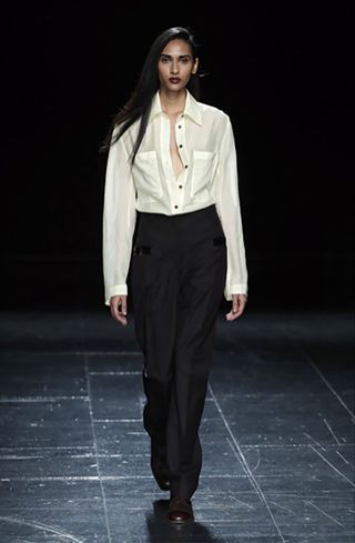 Model wore white shirt and black pant