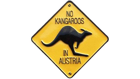 A diamond-shaped yellow sign features a black silhouette of a kangaroo with the text "NO KANGAROOS IN AUSTRIA" written above and below it.