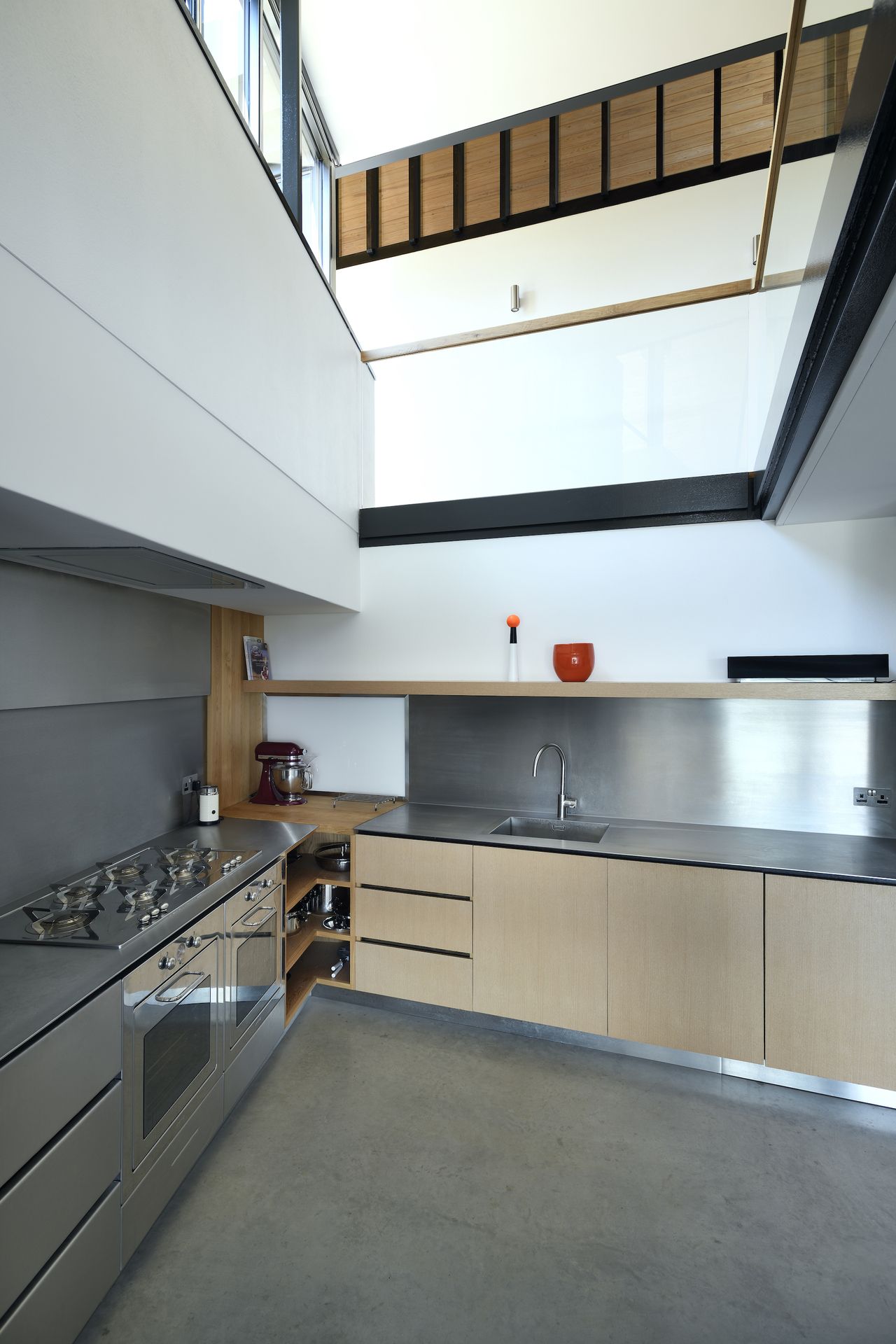 kitchen with gallery above and stainless steel worktop