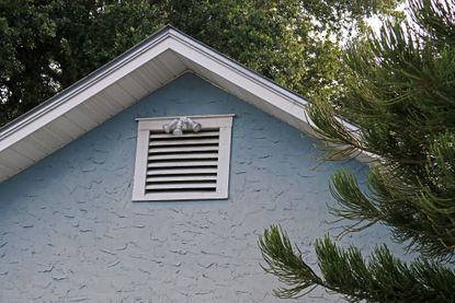 attic ventilation on a blue home