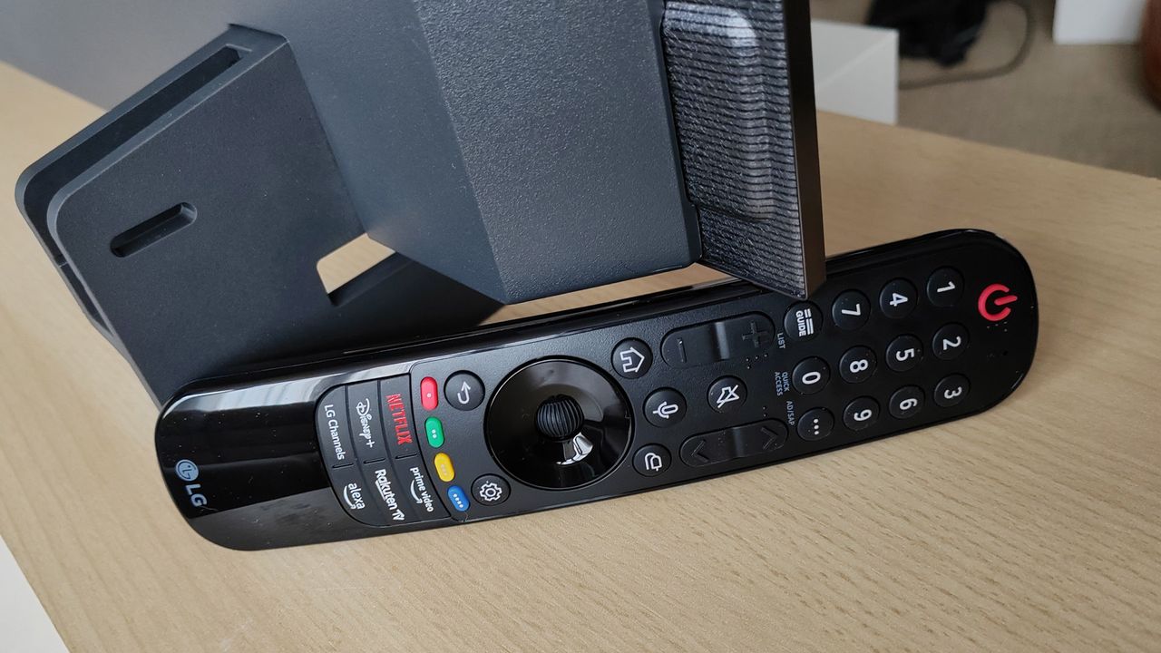 LG OLED C3's magic remote leaning up against the TV