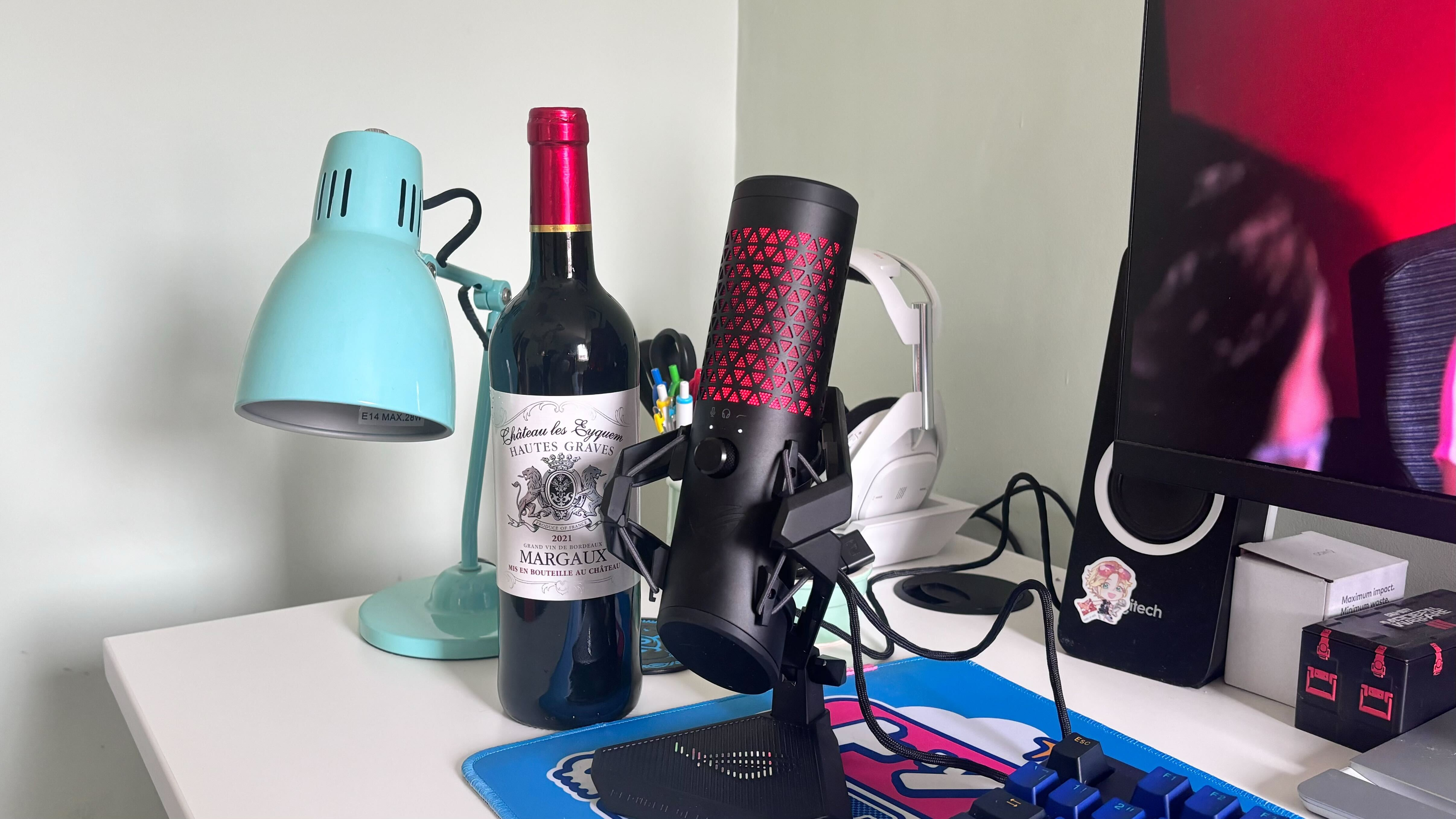 A photo showing the size of the Asus ROG Carnyx relative to a wine bottle.