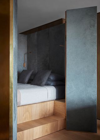dark black bedroom nook with wood step
