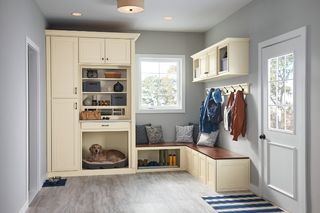 Cream storage unit across a mudroom with pet cubby hole