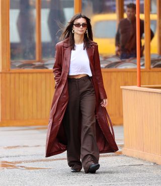 Celebrity autumn outfits: Emily Ratajkowski wears a long coat with tailored trousers