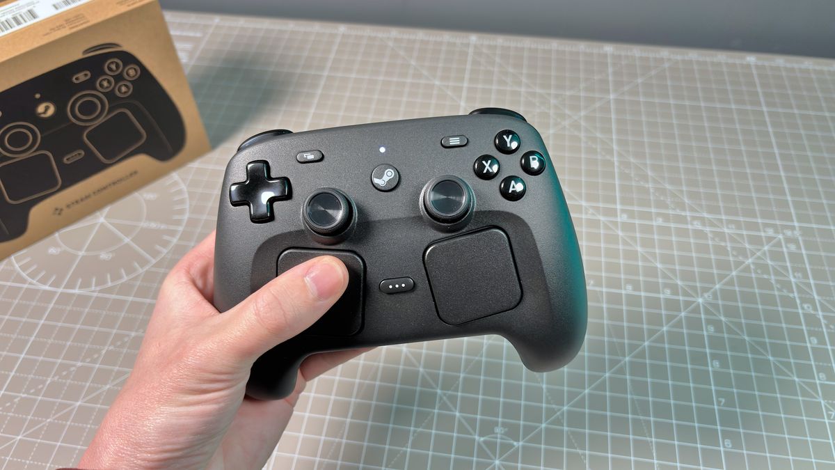 The Steam Controller on a desk during a teardown, with various parts removed.