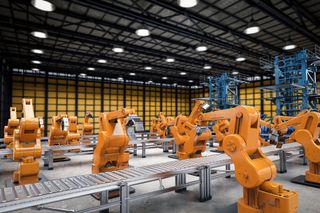 Interiors of a modern factory with orange robots