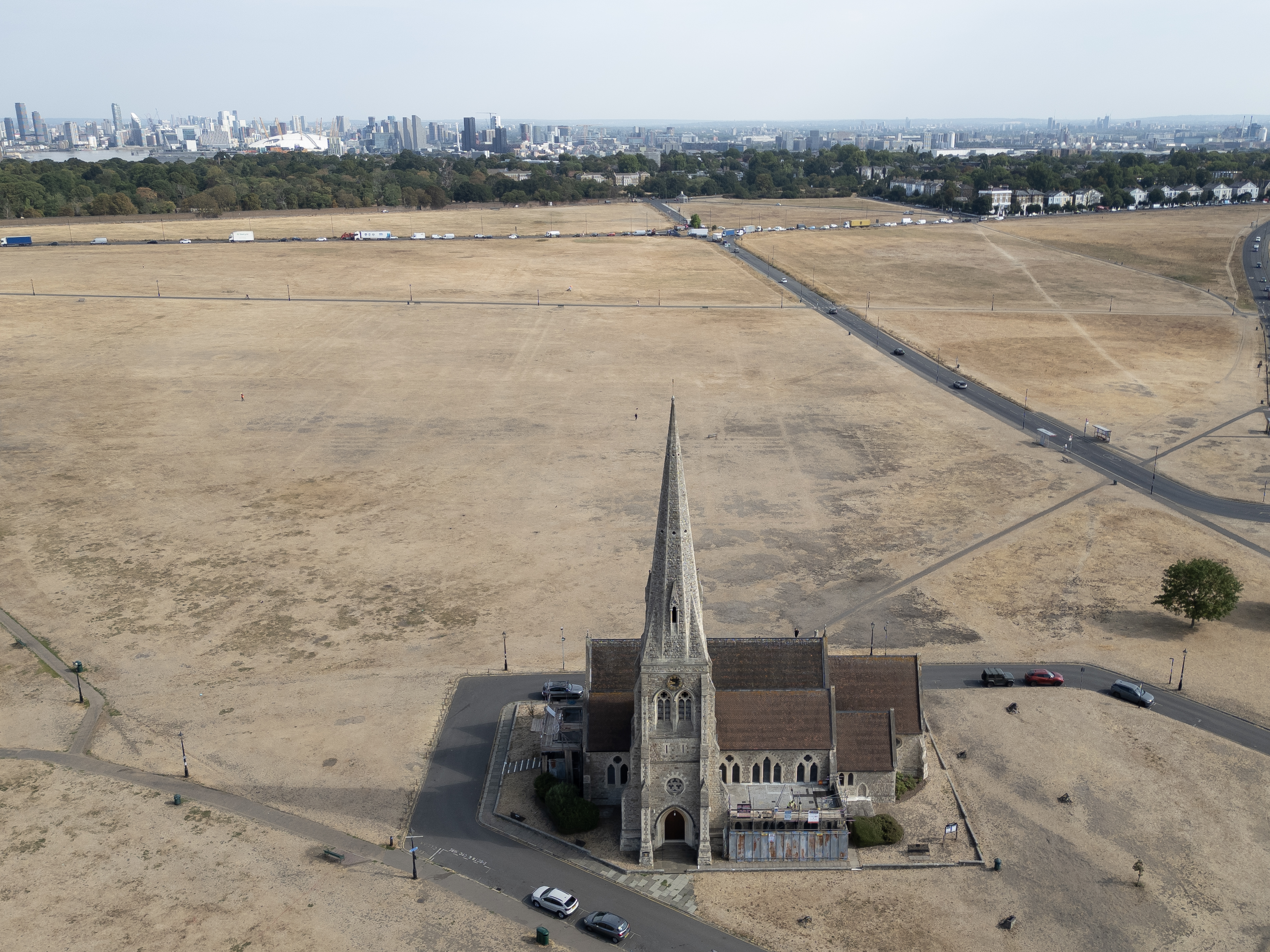 LONDON, UNITED KINGDOM - AUGUST 04: Dried grass surrounds All Saints Church on Blackheath on August 04, 2026 in London, United Kingdom. According to the the National Drought Group, eight areas across southern, central, and eastern England are verging on drought, following a period of "prolonged dry weather," including three heatwaves to hit the region this season. Water companies report seeing a 30% increase in demand for water on the hottest days of the year so far, with more than 20 million households facing hosepipe bans in parts of England and Wales. (Photo by Dan Kitwood/Getty Images)