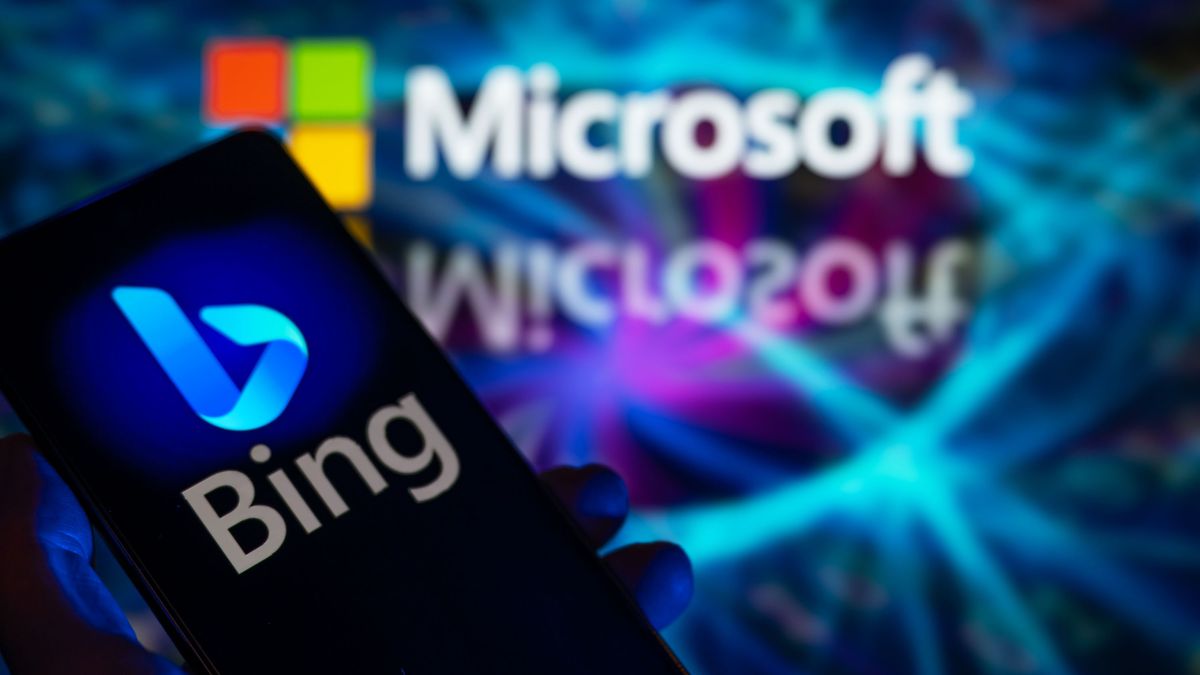 A smart phone is displaying Bing with Microsoft visible in the background in this photo illustration.