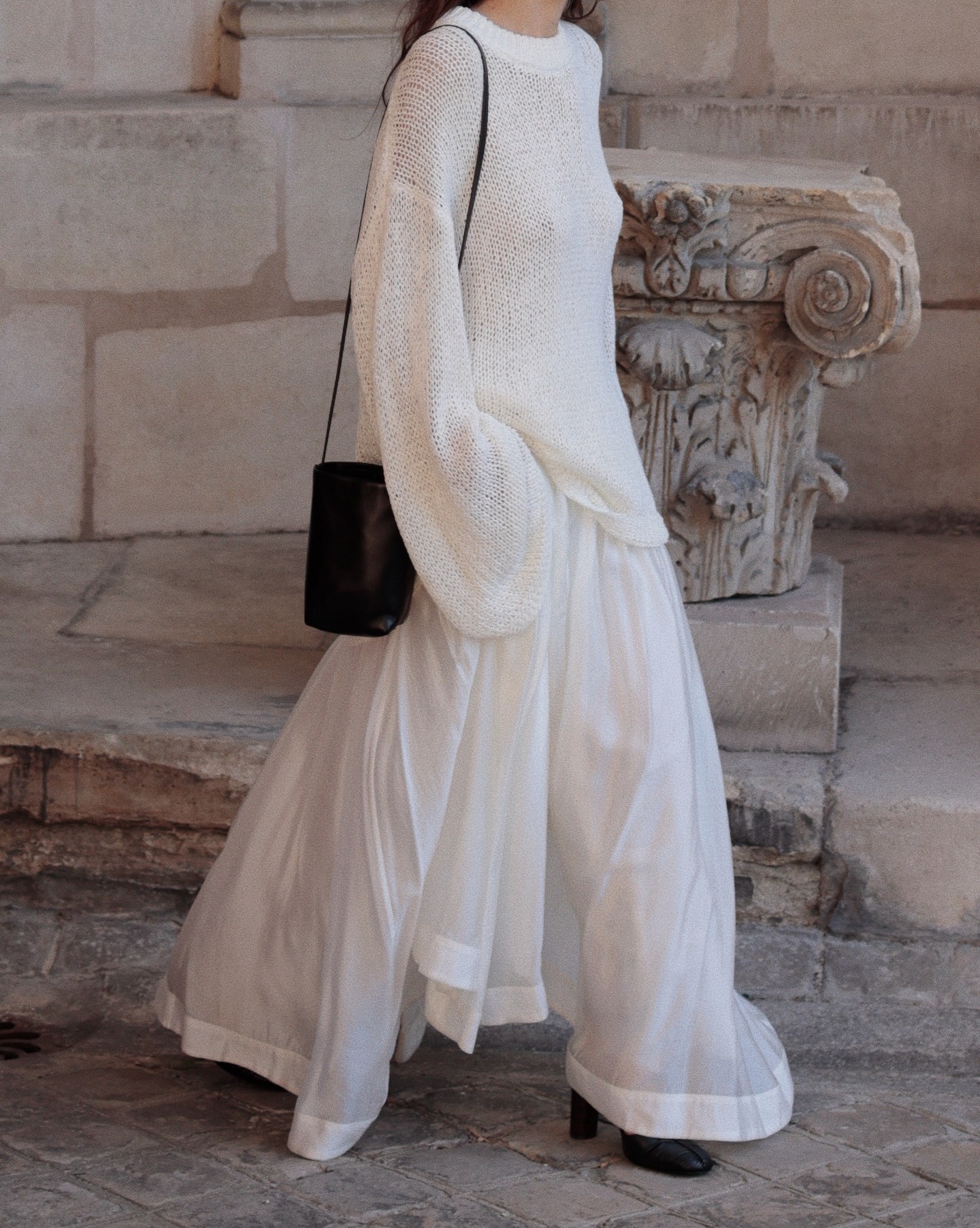 A fashion person wearing an open knit top.