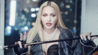 Madonna holding a cane in The Weeknd's music video Popular.