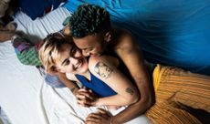 A young LGBT couple laughing and hugging one another. The best sex positions for menstrual cramps