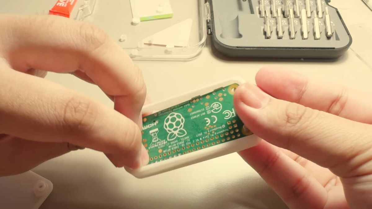 A Raspberry Pi Zero inside a case being assembled.