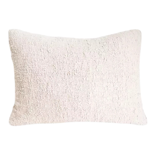An ivory cotton bouclé pillow