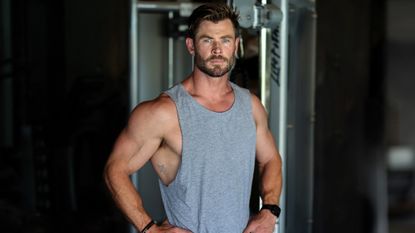 Chris Hemsworth standing in front of a multi gym