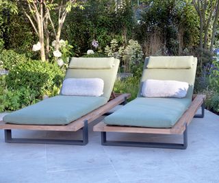 two sun loungers on a paved patio