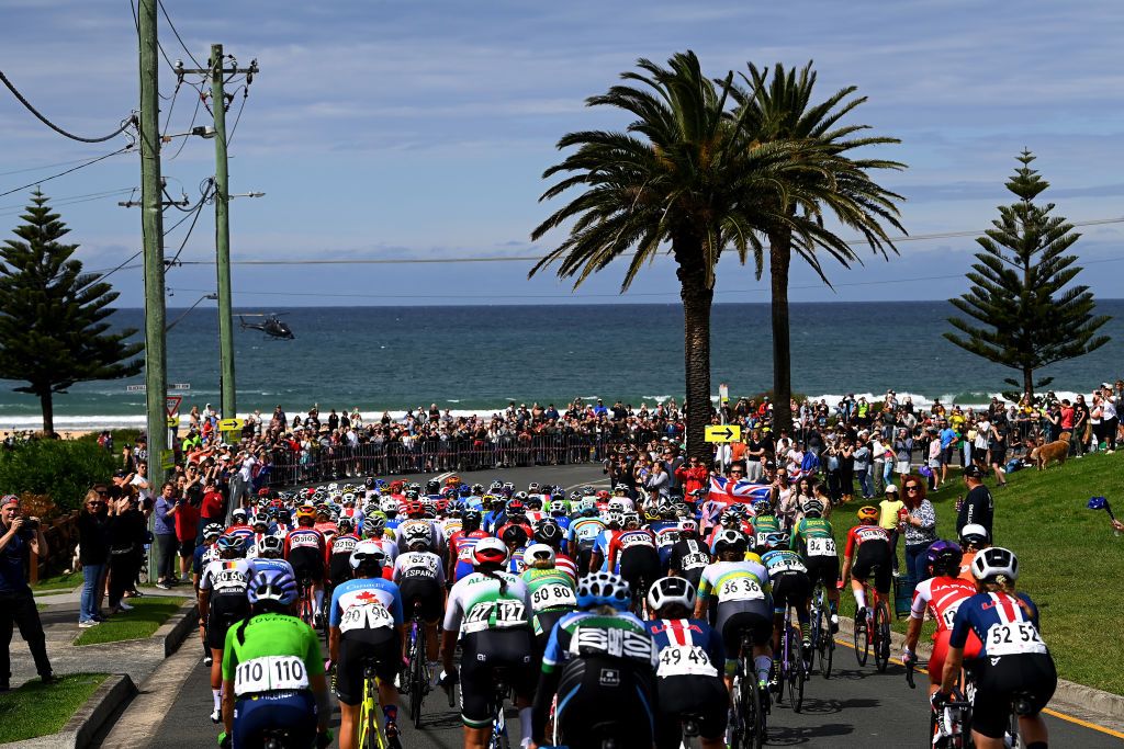 WOLLONGONG AUSTRALIA SEPTEMBER 24 A general view of the peloton compete passing through Bulli village while fans cheer during the 95th UCI Road World Championships 2022 Women Elite Road Race a 1643km one day race from Wollongong to Wollongong Wollongong2022 on September 24 2022 in Wollongong Australia Photo by Tim de WaeleGetty Images