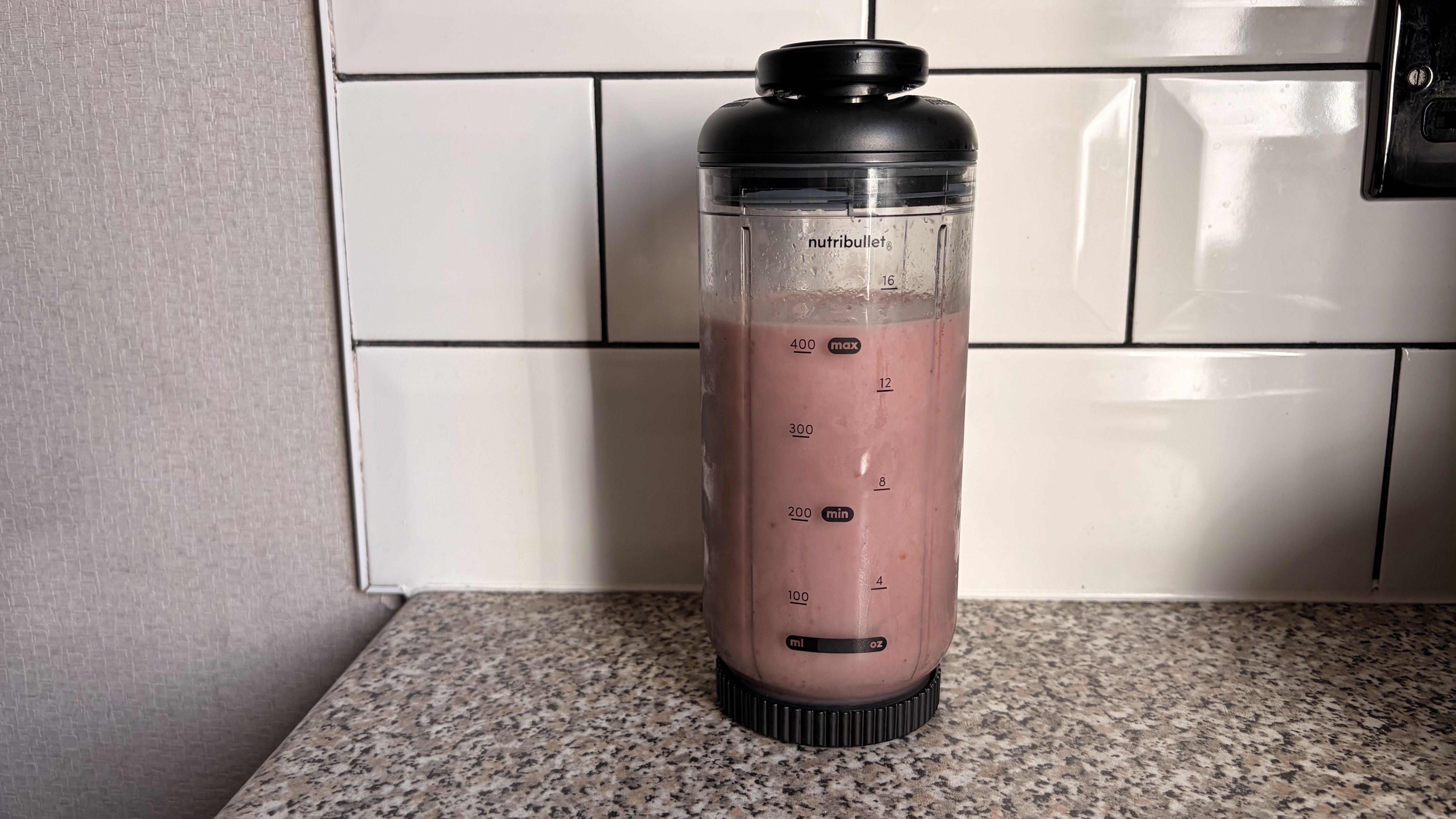 Smoothie made in the Nutribullet Flex blender photographed on a white background