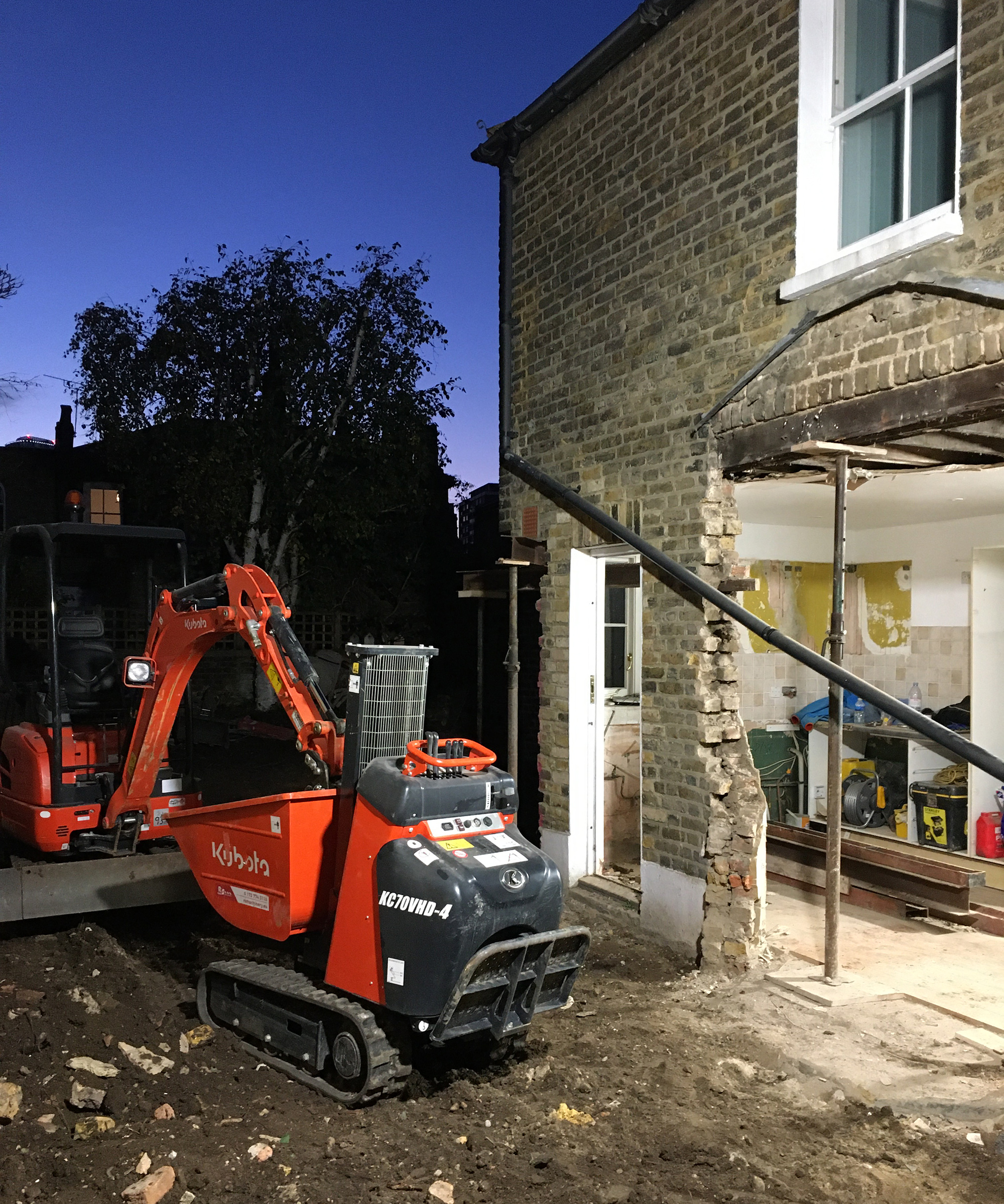 A progress shot of a kitchen extension project with small digger