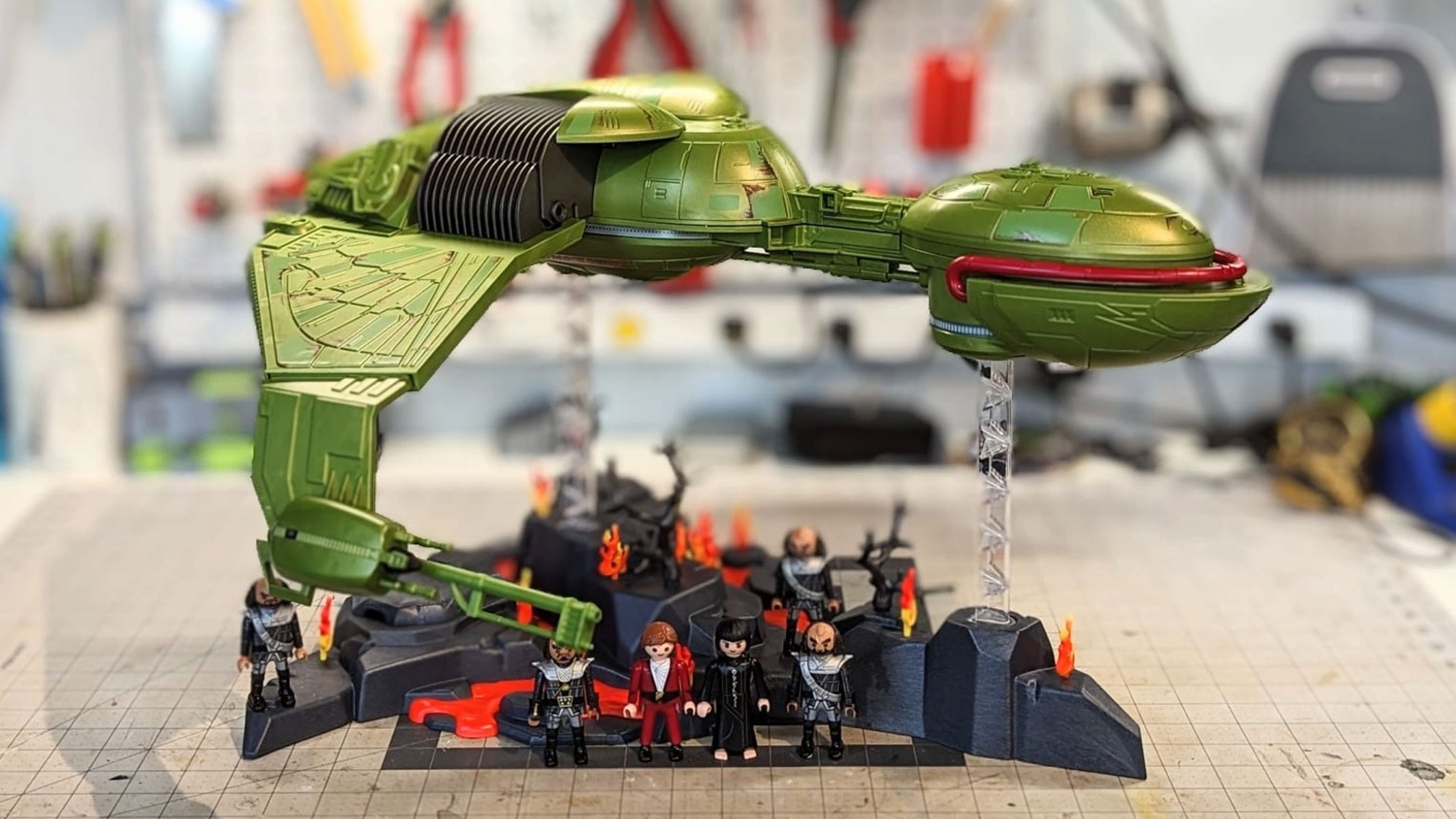 A Star Trek Klingon playmobil set on a work bench with tools out of focus in the background