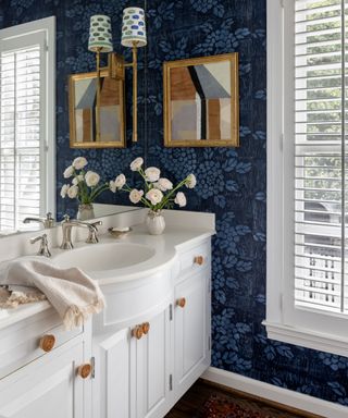 powder room with dark blue wallcovering and lamps