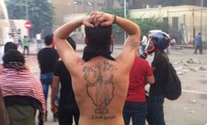 A Christian man with a jesus tattoo on his back, Cairo.