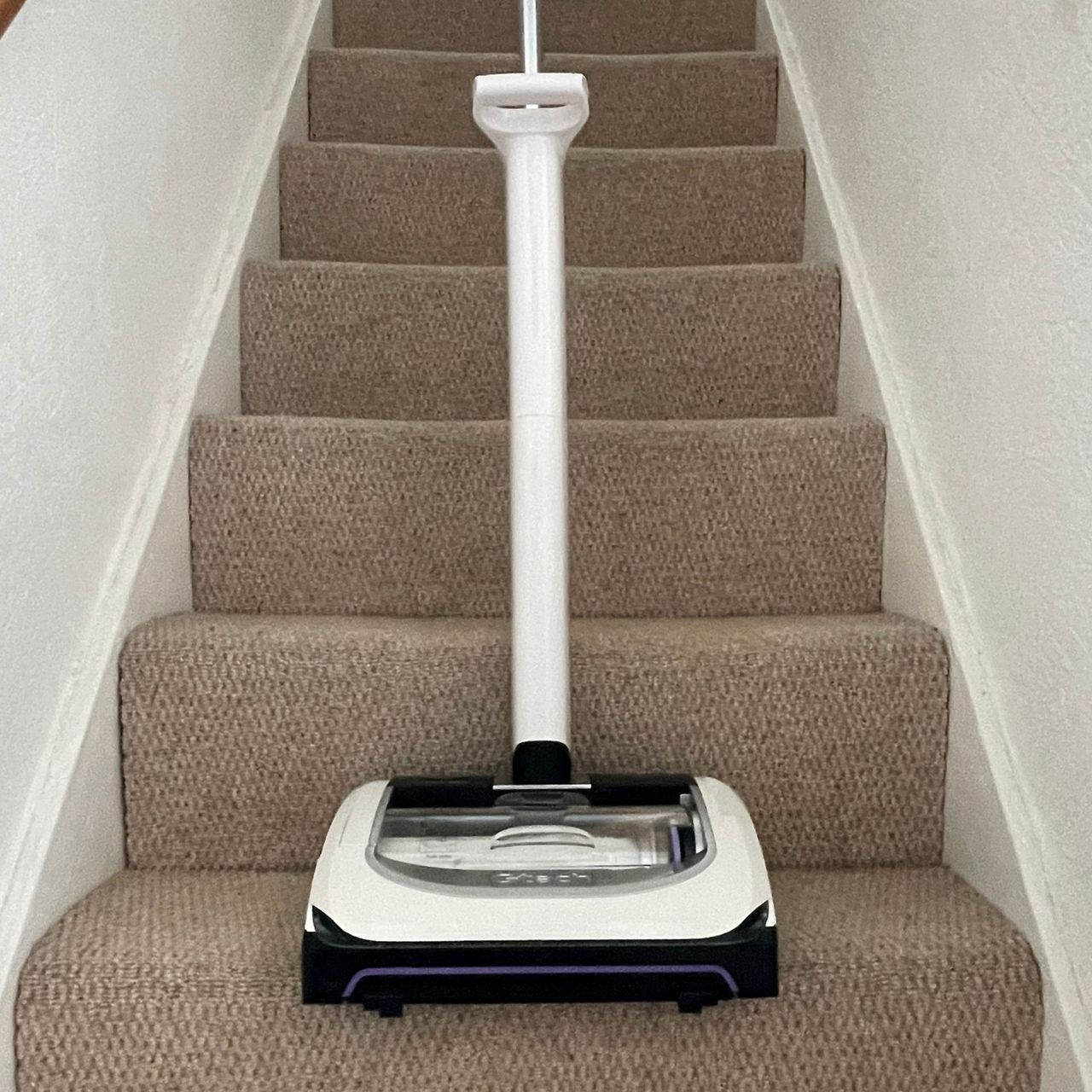 Gtech airram platinum standing on carpeted stairs