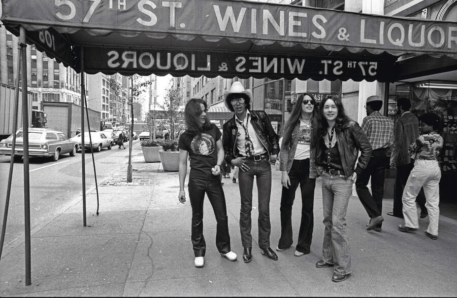 Thin Lizzy pose beneath an awning on 57th Street, New York City
