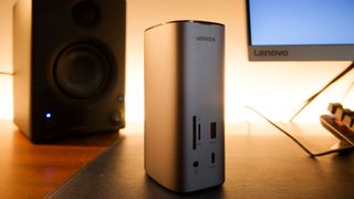 A silver Ugreen USB-C Triple Display Docking Station sitting on a desk