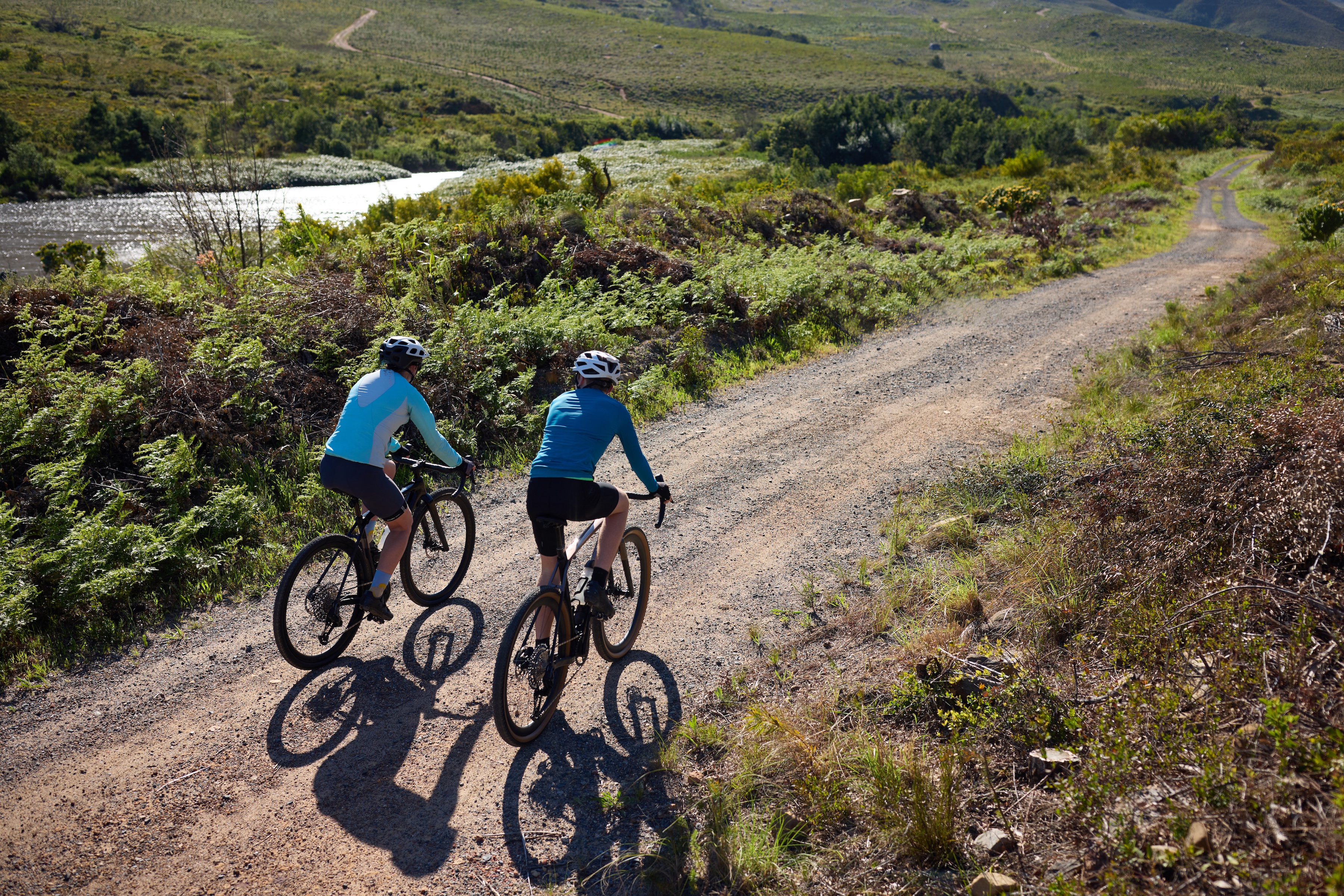 Two people riding gravel side by side