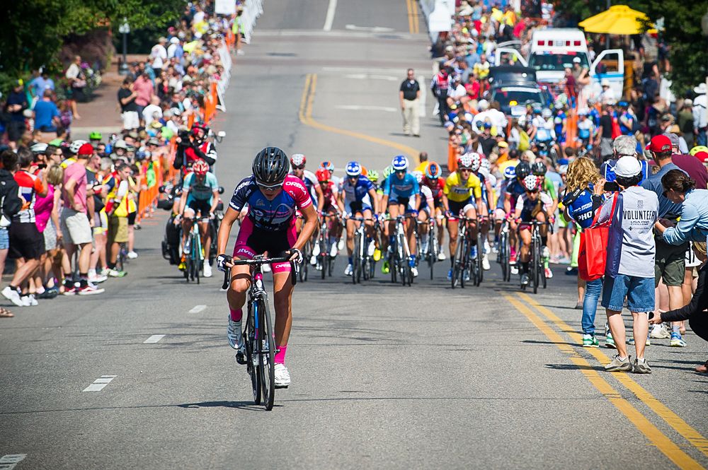 Amanda Miller (Visit Dallas p/b Noise4Good) makes an attack along Washington Street and solos up the climb with the field watching.