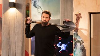 Ian Grimm (Rob McElhenney) with a shovel over his shoulders in Mythic Quest