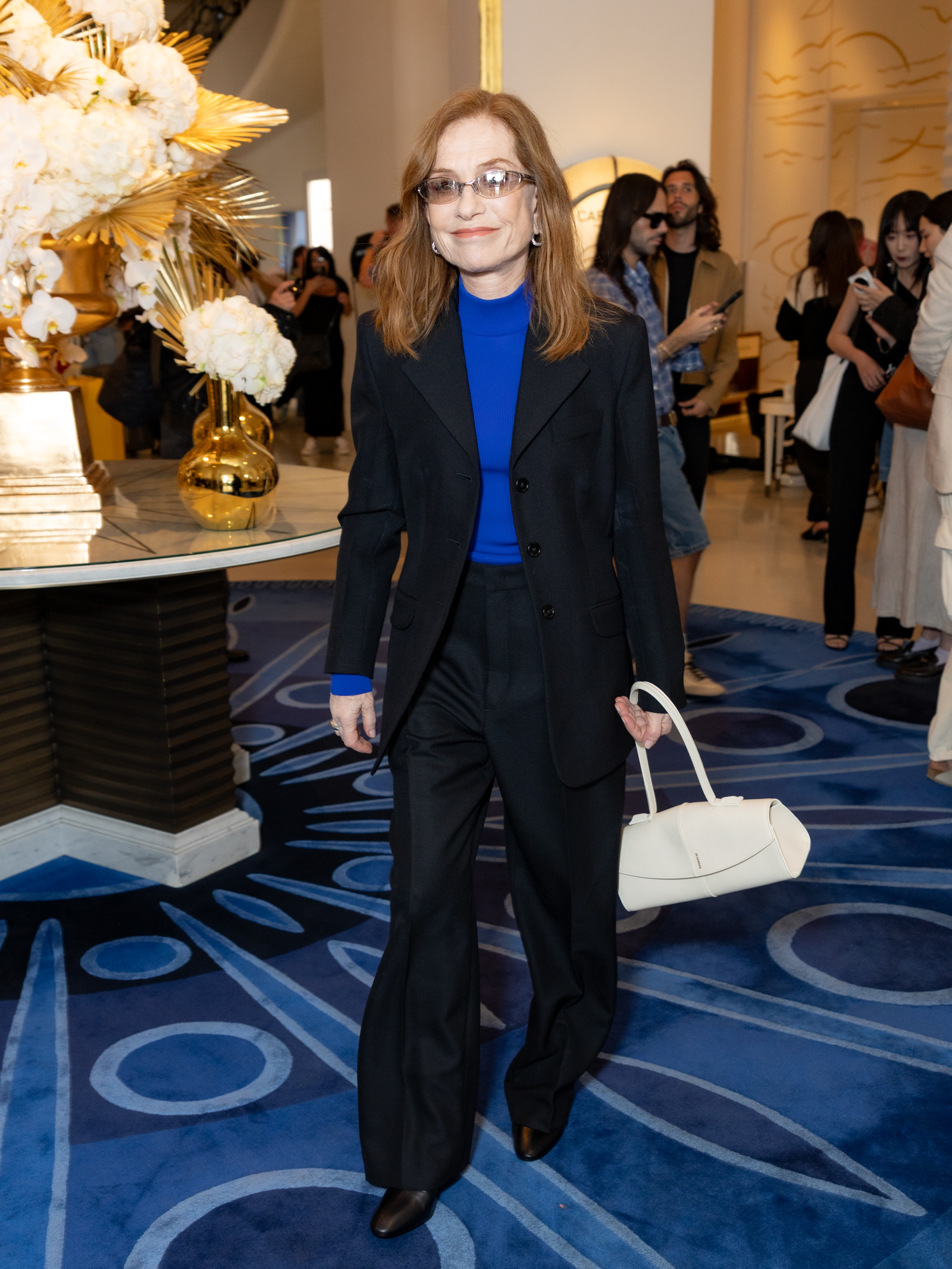 An image of Isabelle Huppert wearing an over over 50s French fashion trend at the 2026 Cannes Film Festival.
