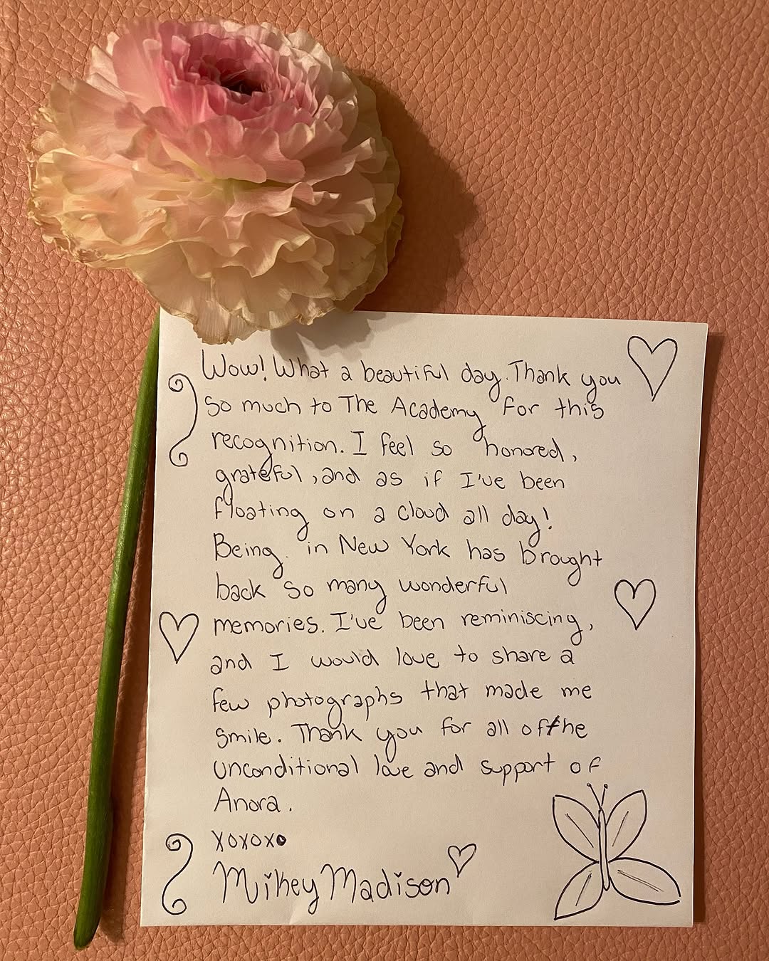 A handwritten letter by Mikey Madison and flower