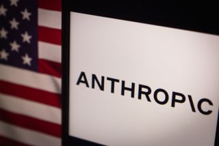 The Anthropic logo displayed on a screen with the flag of the United States in the background.