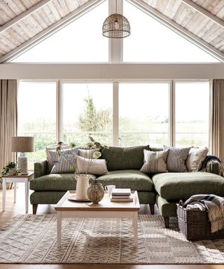 green sofa, wooden ceiling, windows