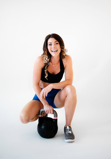trainer sits with kettlebell