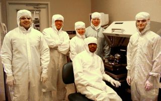 Stanford researchers (doctoral students, undergraduates, high-school interns) in their "bunny suits" at the Stanford Nanofabrication facility. The team created a robust carbon nanotube technology that could enable highly energy-efficient computing systems.