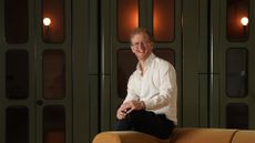 Ross McNairn, CEO and Co-founder of Edinburgh-based startup, Wordsmith AI, pictured sitting on a couch.