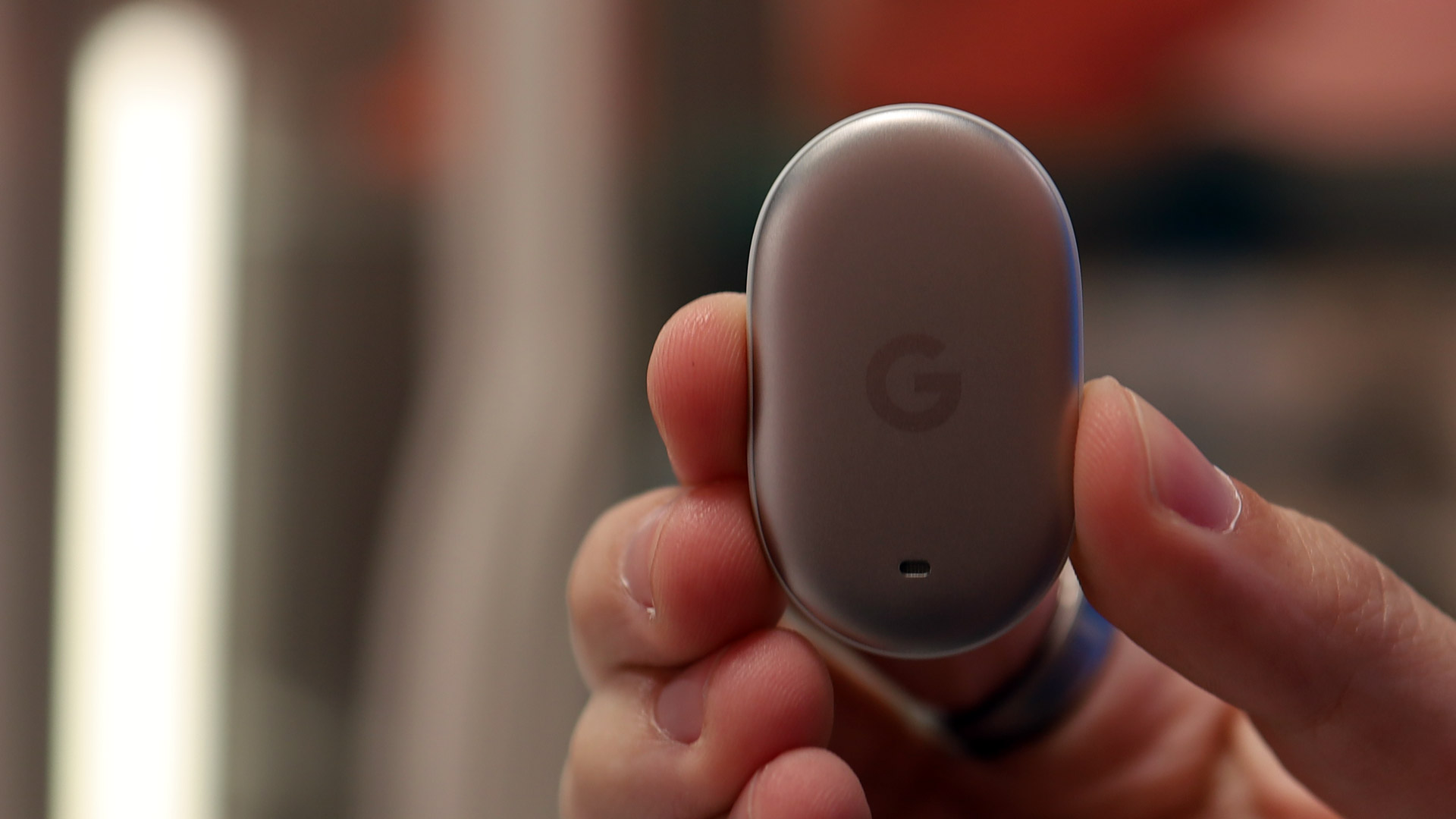 A hand holding the Google Pixel Tag