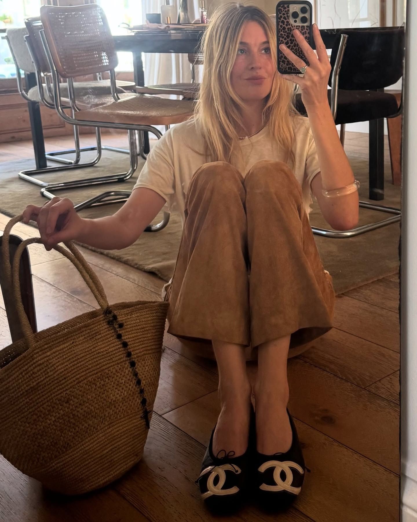 Camille Charriere wearing cropped wide-leg suede pants with a white T-shirt and Chanel ballet flats.