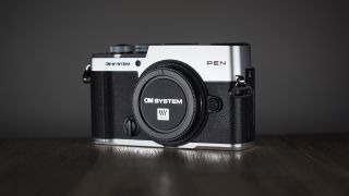 OM System OM-3 on a wooden surface