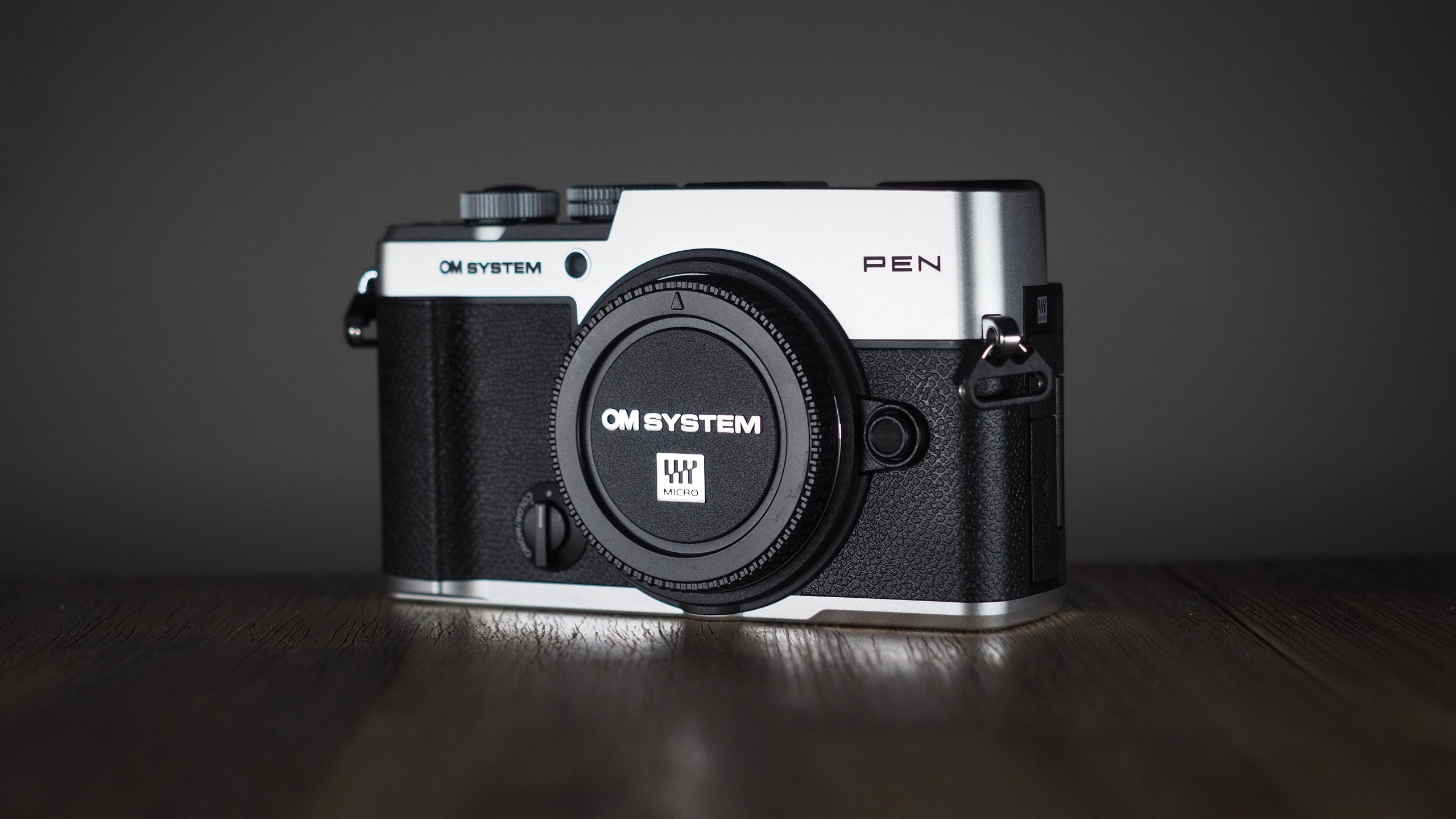 OM System OM-3 on a wooden surface
