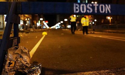 A piece of debris rests against a police barricade near the scene of a twin bombing at the Boston Marathon.