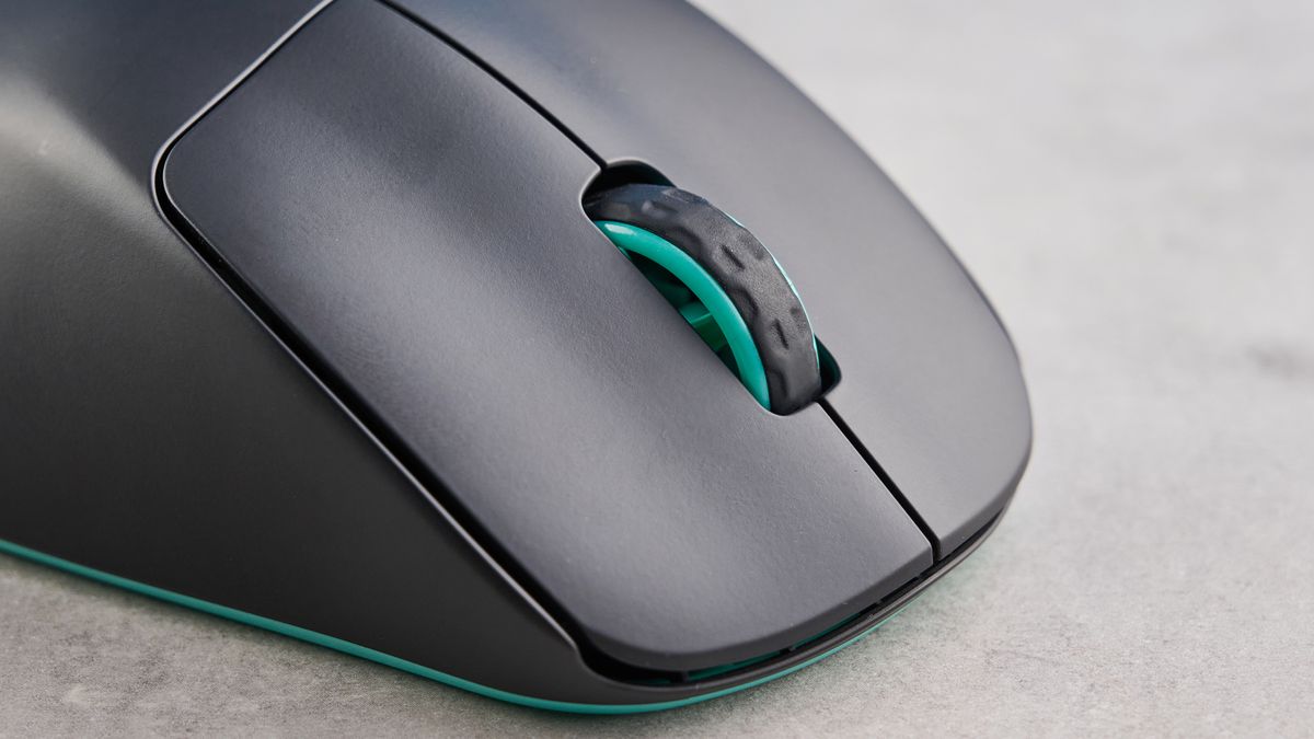 A black and teal Cherry XTRFY M64 Wireless gaming mouse