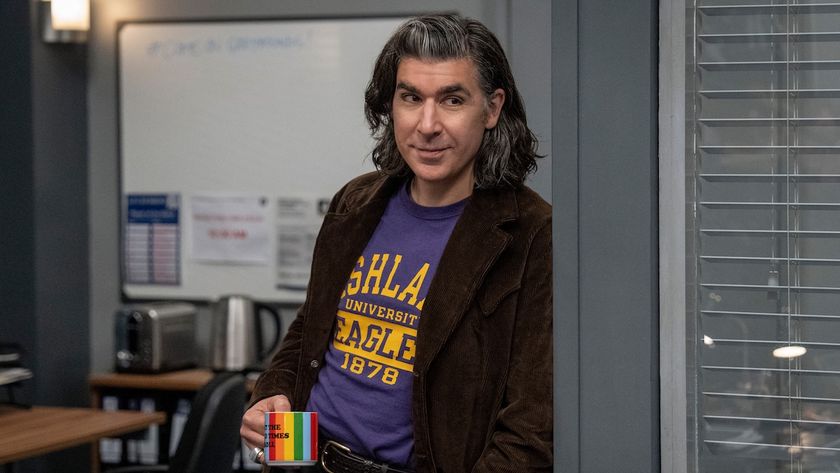 James Lance&#039;s Trent Crimm holding rainbow-styled coffee mug while standing inside Ted Lasso&#039;s office