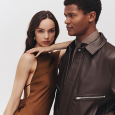 Two models wearing a Reiss brown dress and a brown leather jacket