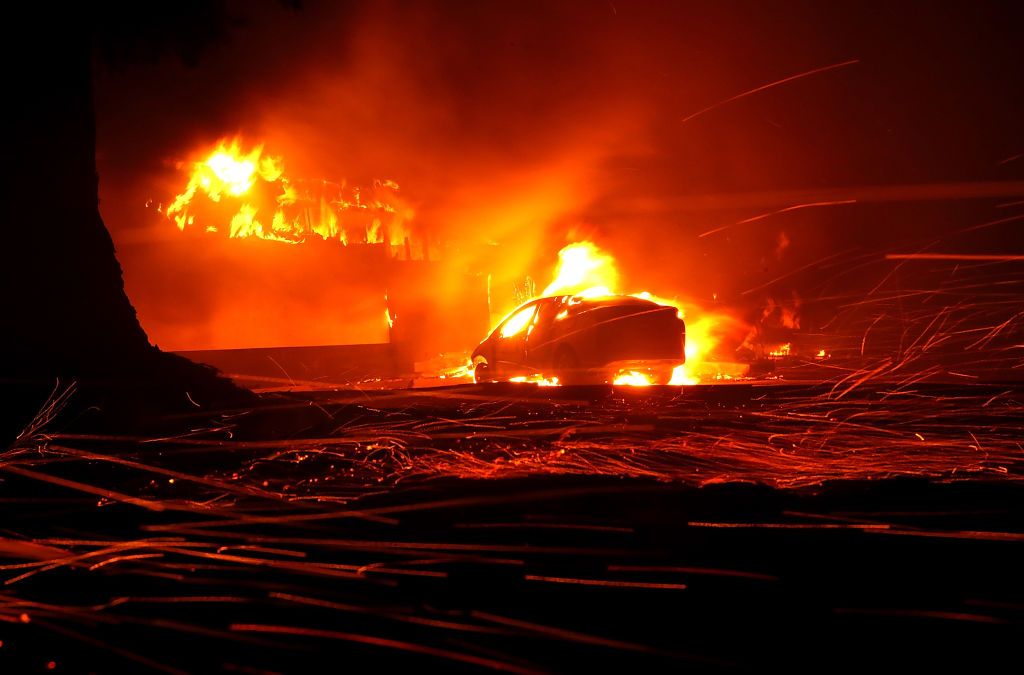 Embers blow in the wind as a Camp Fire burns a KFC restaurant on November 8, 2018 in Paradise, California.