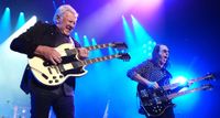 Alex Lifeson and Geddy Lee of Rush rock double-necks during a 2026 reunion show in LA.