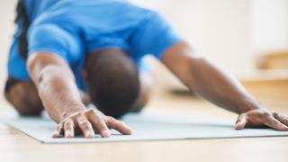 A man doing childs pose in yoga
